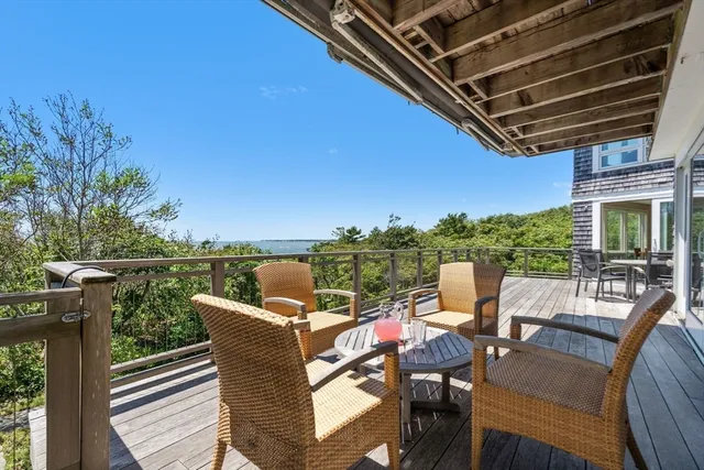 a view of a patio with table and chairs and wooden floor