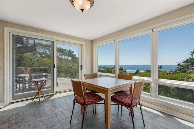 a room with furniture pool table and windows