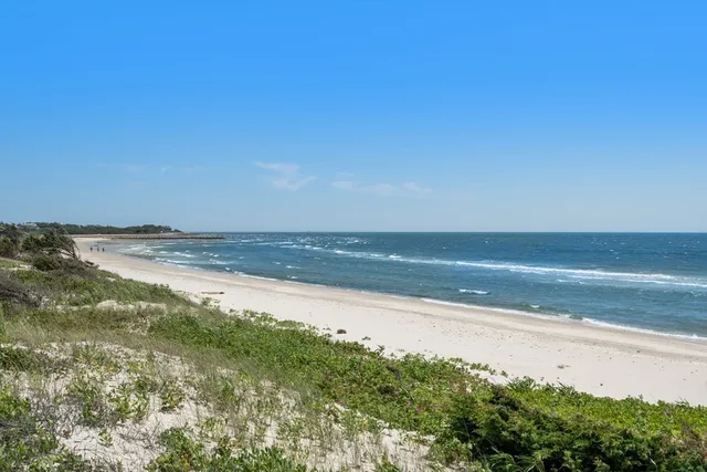 an aerial view of a house with a yard and lake view