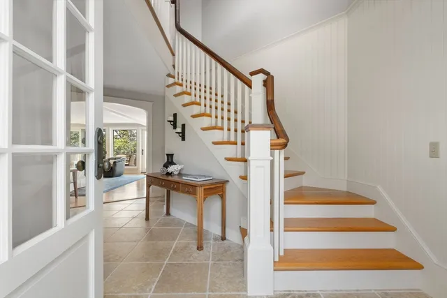 a living room with furniture large window and a fireplace
