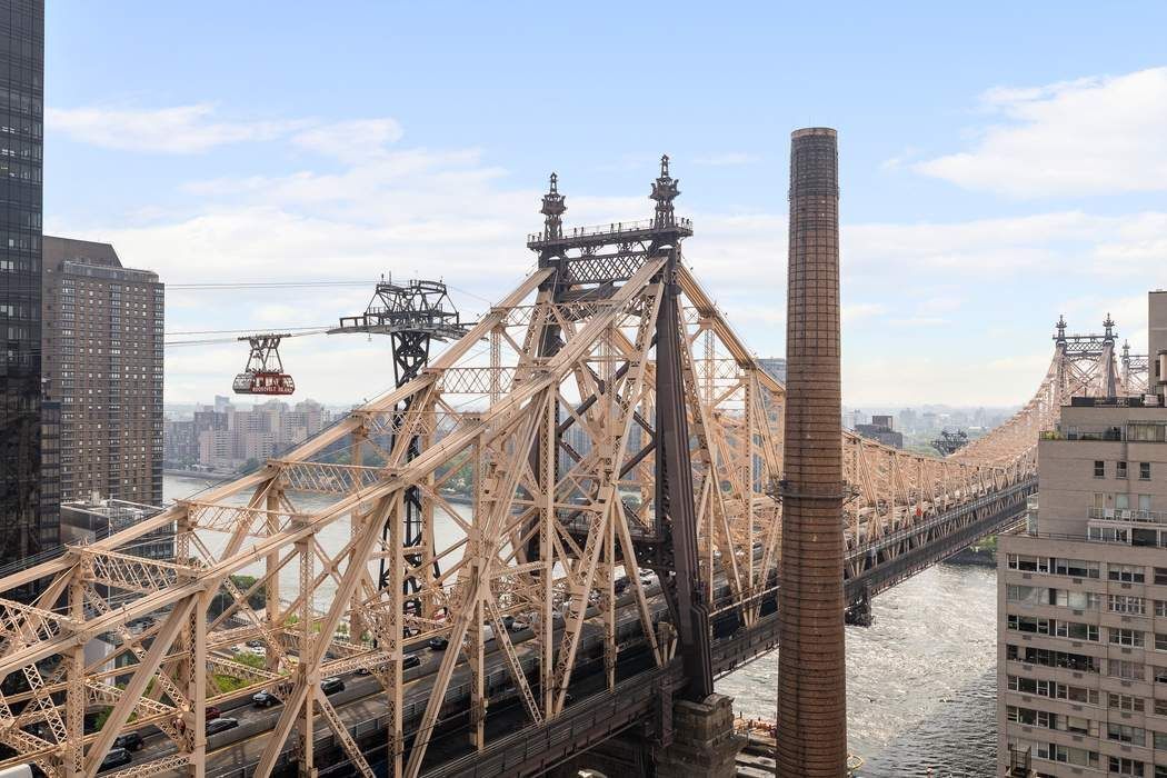 425 East 58th Street, Unit 21E Manhattan, NY 10022 - Photo 1 of 19 a view of a city with tall buildings