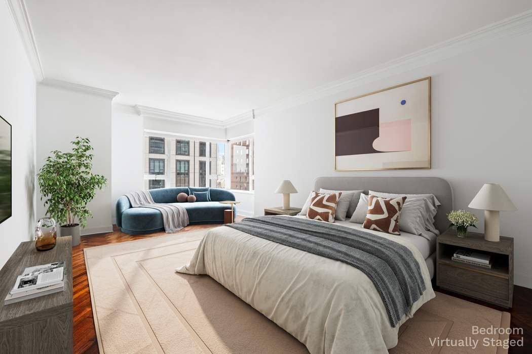 425 East 58th Street, Unit 21E Manhattan, NY 10022 - Photo 10 of 19 a bedroom with a large bed and a couch