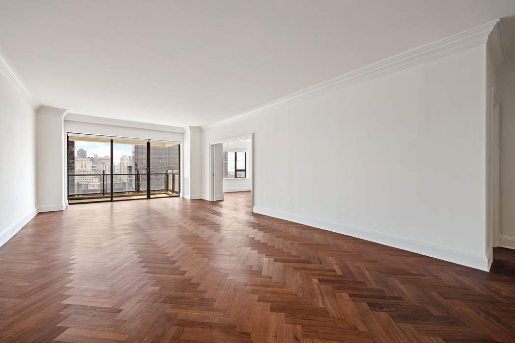 425 East 58th Street, Unit 21E Manhattan, NY 10022 - Photo 3 of 19 a view of an empty room with glass door
