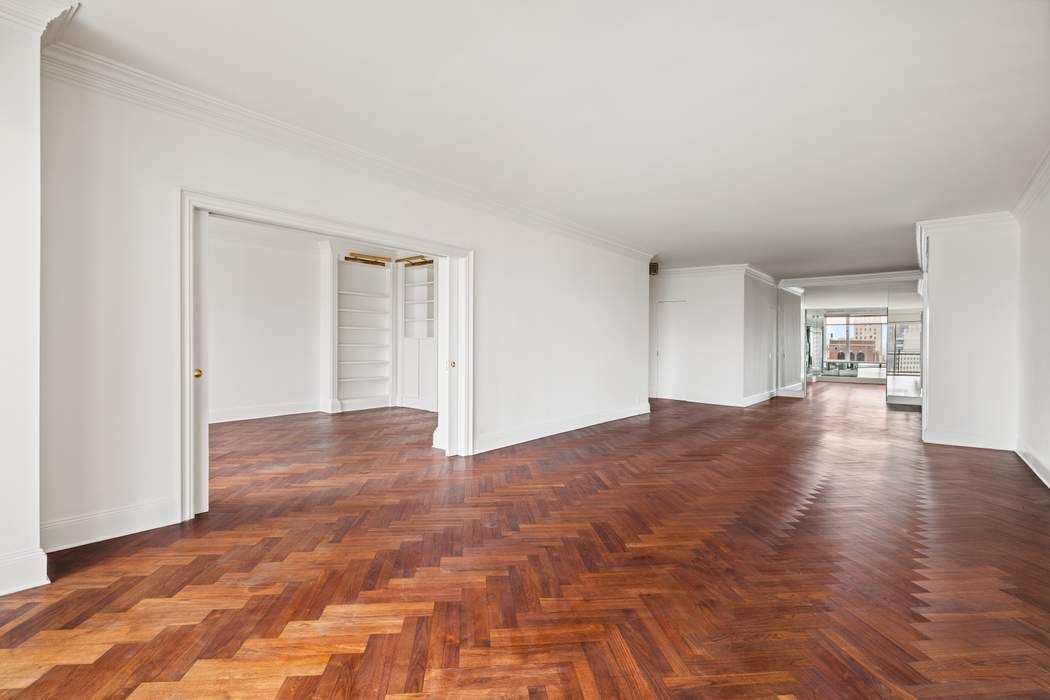 425 East 58th Street, Unit 21E Manhattan, NY 10022 - Photo 4 of 19 a view of empty room with wooden floor