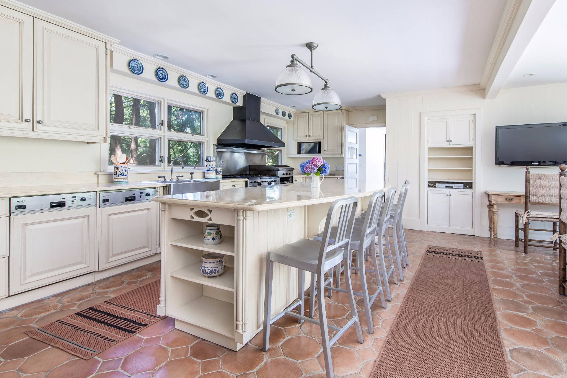 86 Georgica Road East Hampton, NY 11937 - Photo 12 of 20 a kitchen with stainless steel appliances granite countertop a stove a sink and a refrigerator
