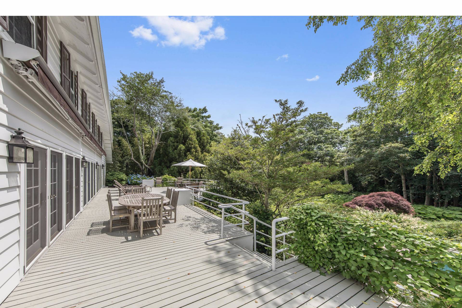 86 Georgica Road East Hampton, NY 11937 - Photo 16 of 20 a view of a chairs and table on the wooden deck
