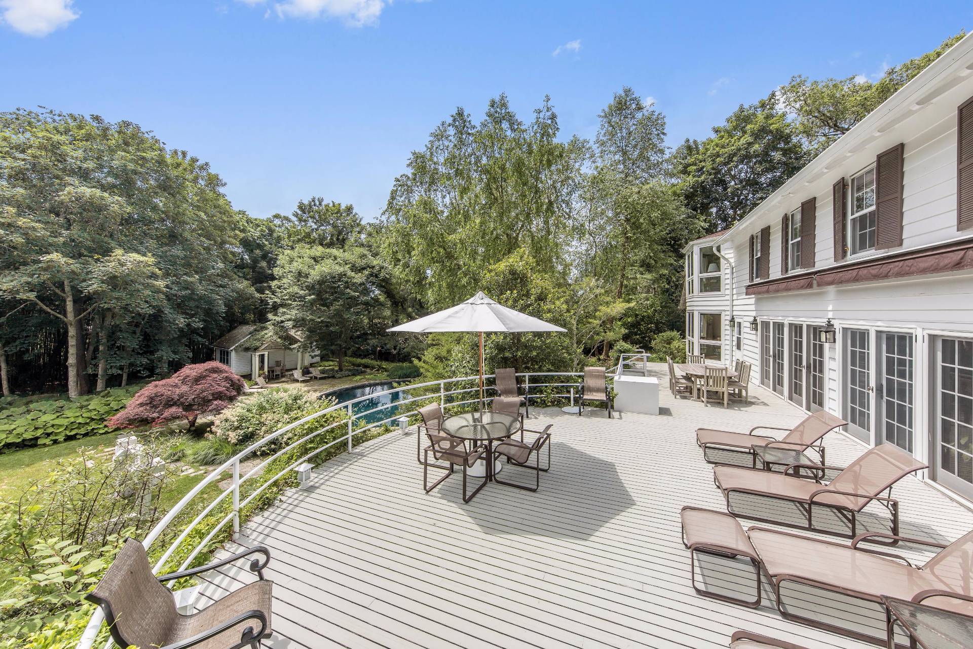 86 Georgica Road East Hampton, NY 11937 - Photo 18 of 20 a view of a patio with furniture and a yard