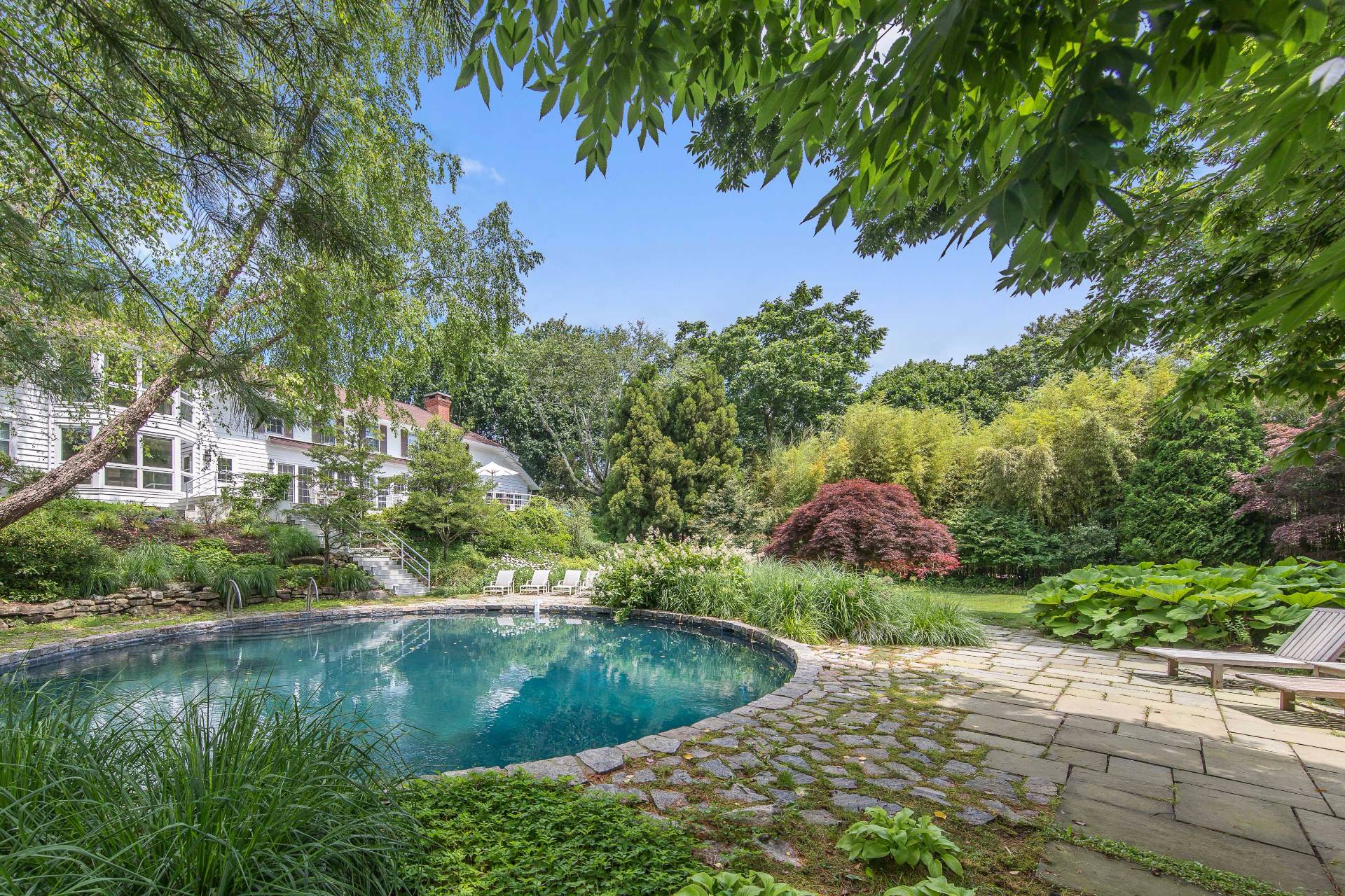 86 Georgica Road East Hampton, NY 11937 - Photo 20 of 20 a view of a garden with a fountain