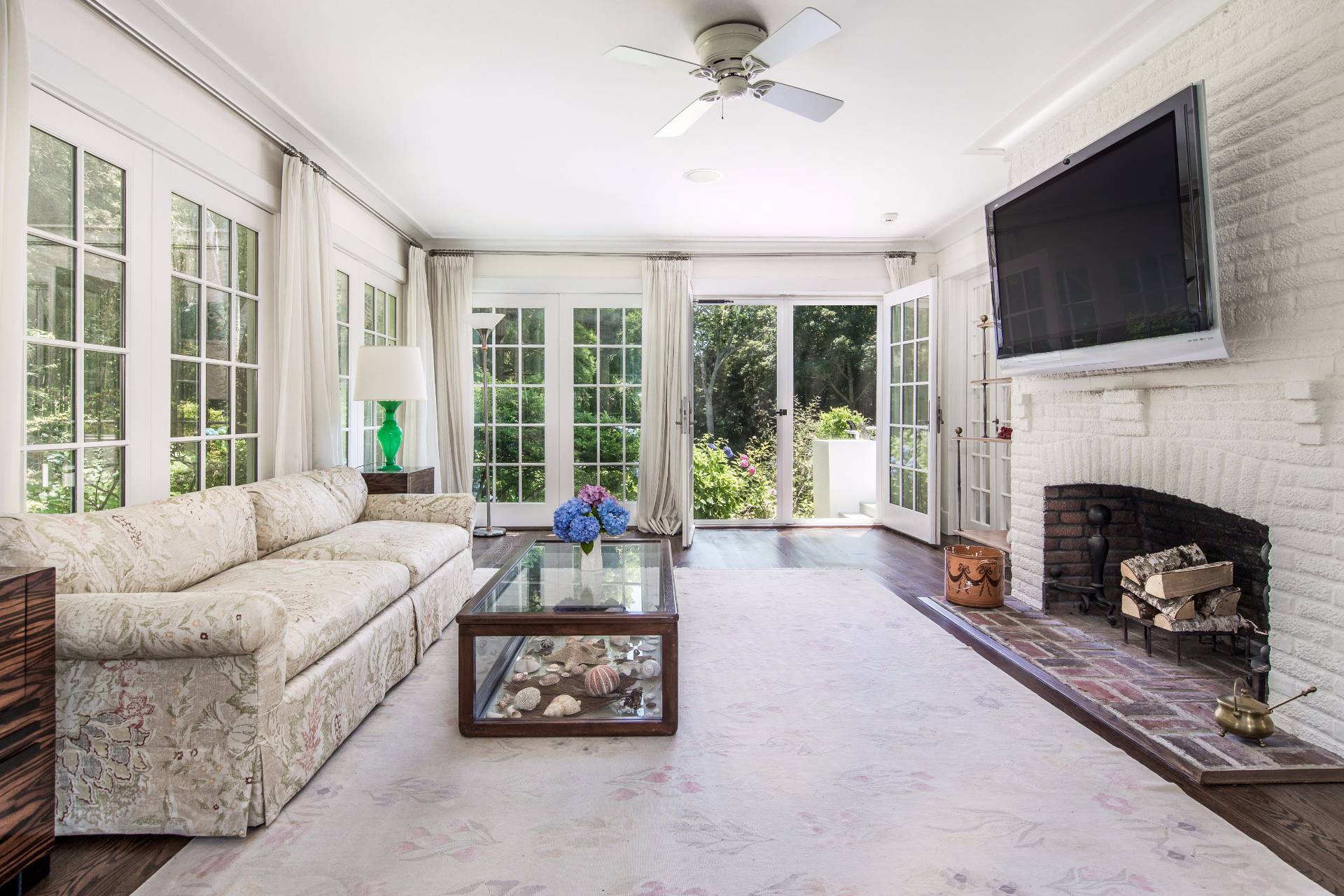 86 Georgica Road East Hampton, NY 11937 - Photo 6 of 20 a living room with furniture a flat screen tv and a fireplace