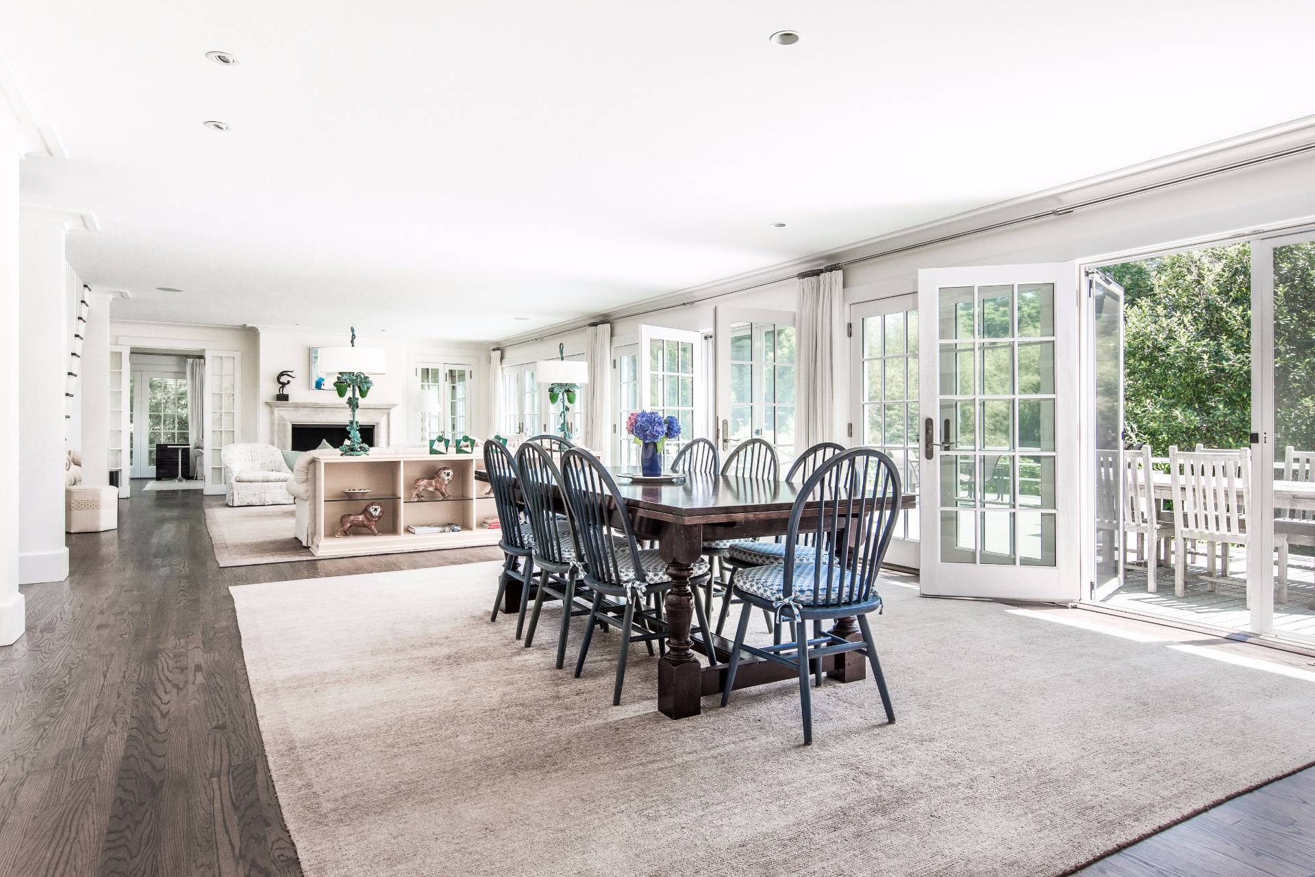 86 Georgica Road East Hampton, NY 11937 - Photo 10 of 20 a view of a dining room and livingroom with furniture wooden floor and a rug