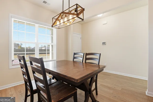 a dining room with furniture and window