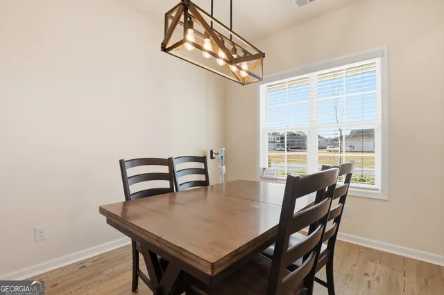 a kitchen with kitchen island granite countertop a sink a stove a refrigerator cabinets and a counter top space
