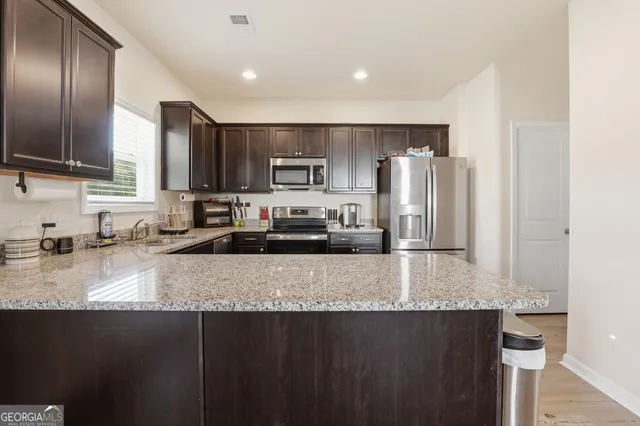 a kitchen with a refrigerator sink and microwave