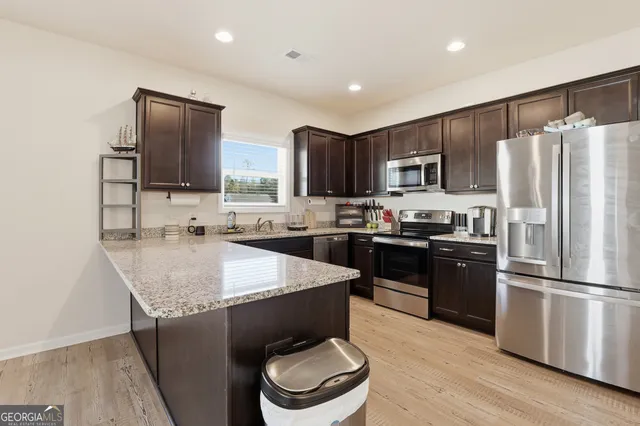 a kitchen with stainless steel appliances and wooden cabinets