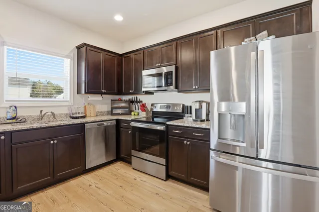 a kitchen with a sink and a mirror