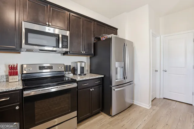 a kitchen with a sink stove and microwave