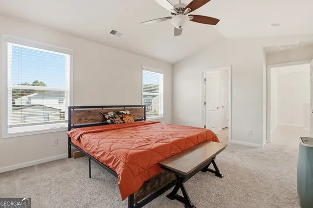 a bathroom with a granite countertop sink a toilet and a large mirror