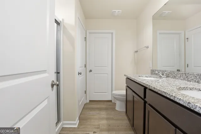 a bedroom with a bed and a view of en suite bathroom
