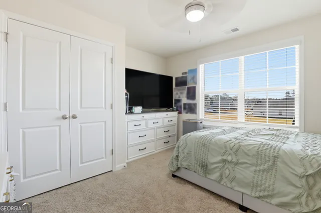 a view of walk in closet with clothes