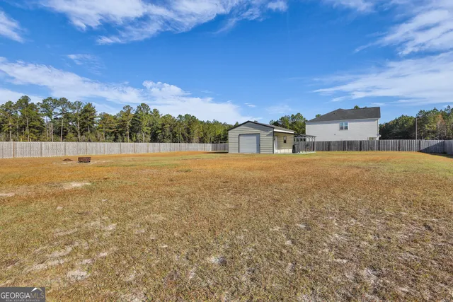 a view of a house with a yard and deck
