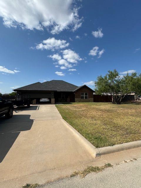 a black and white house with a yard