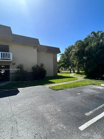 a view of a house with a yard and garage