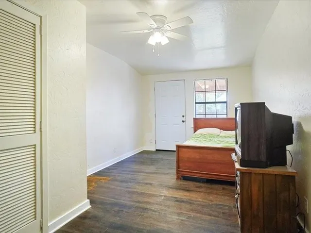 a bedroom with furniture and wooden floor
