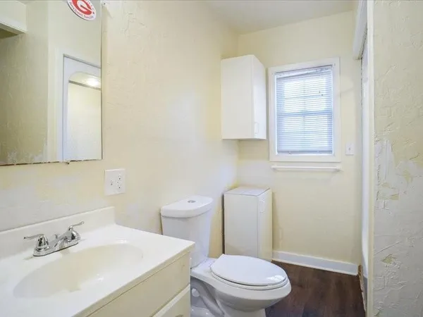 a white toilet sitting next to a bathroom sink