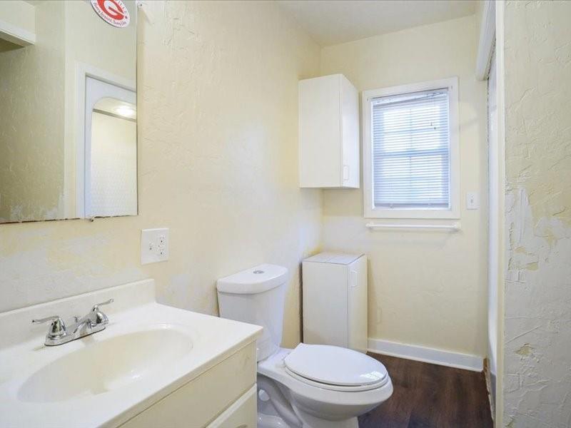 33 Park Lane Gainesville, TX 76240 - Photo 14 of 22 a white toilet sitting next to a bathroom sink