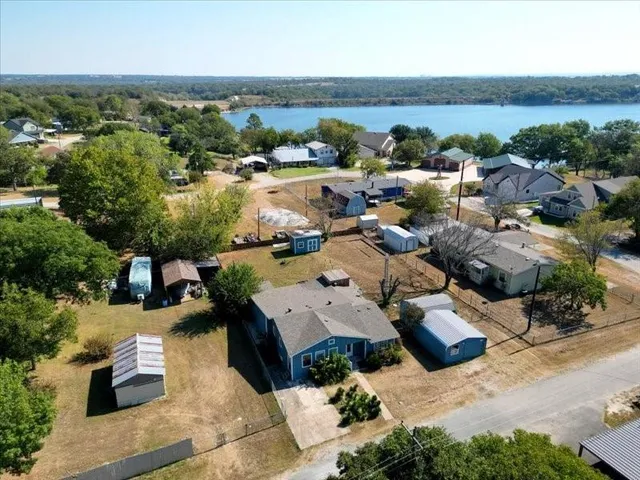 an aerial view of a house with yard swimming pool and lake view