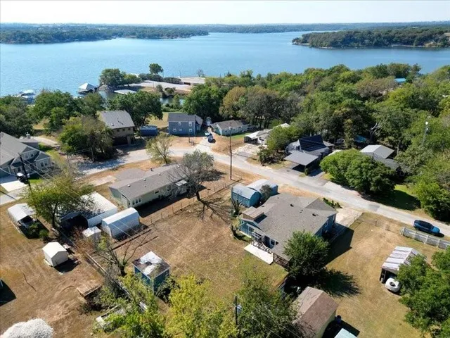 an aerial view of a house with lake view
