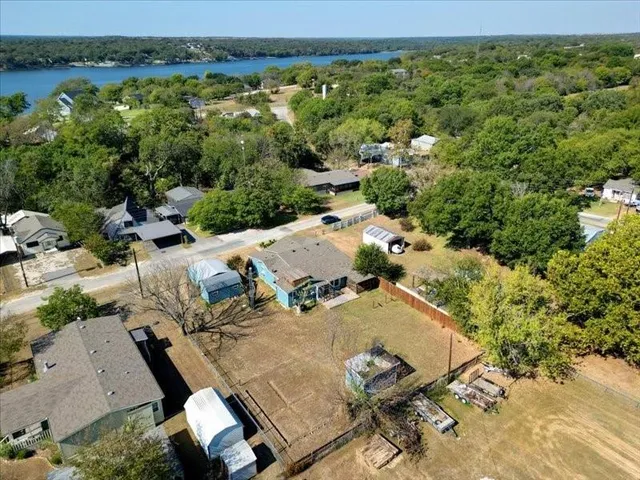 an aerial view of a swimming pool with a yard