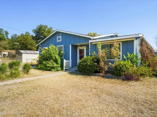 a front view of house with yard and green space