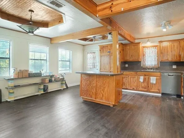 a living room with furniture and kitchen view