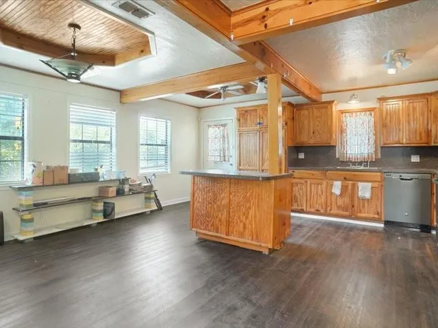 a living room with furniture and kitchen view