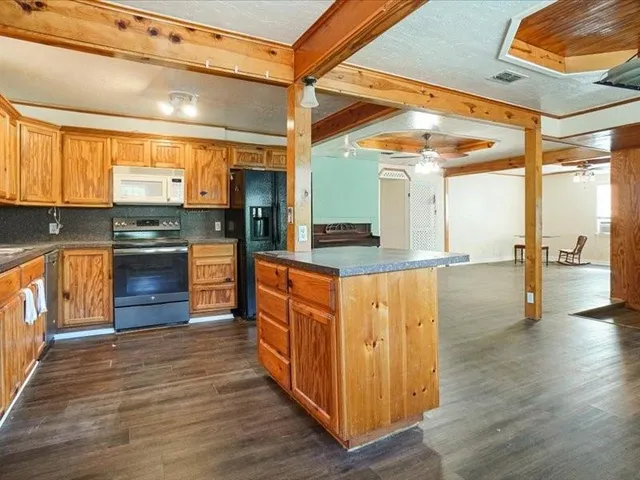 a kitchen with stainless steel appliances granite countertop a stove a sink and a refrigerator