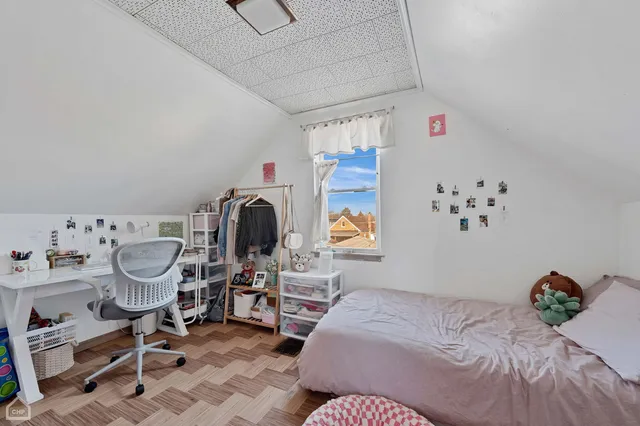 a bedroom with a bed and a chandelier