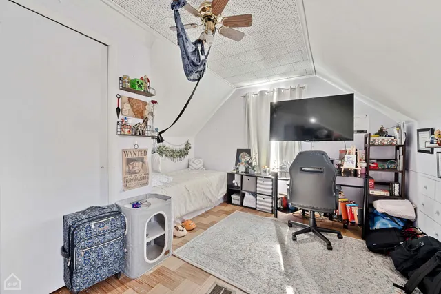 a bedroom with furniture and a flat screen tv