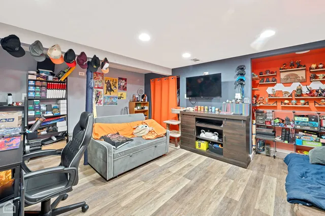 a living room with furniture a flat screen tv and a fireplace