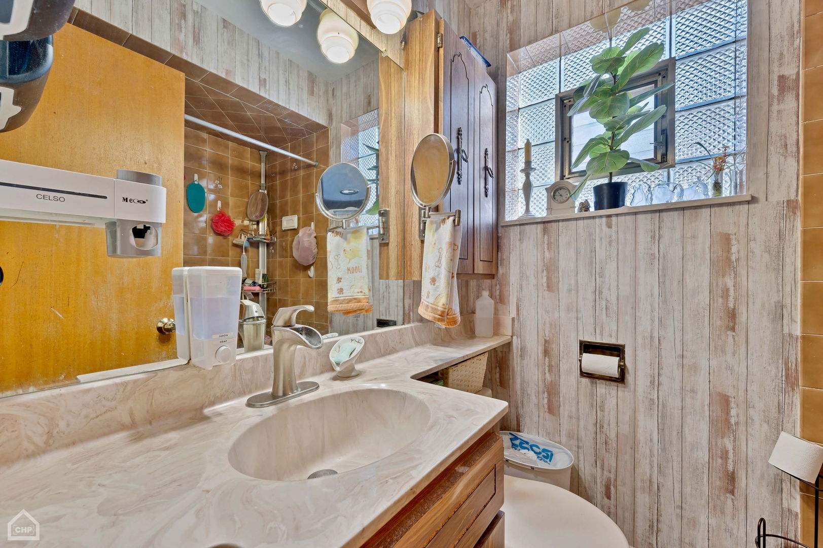 3736 West 70th Street Chicago, IL 60629 - Photo 7 of 21 a bathroom with a sink and a mirror