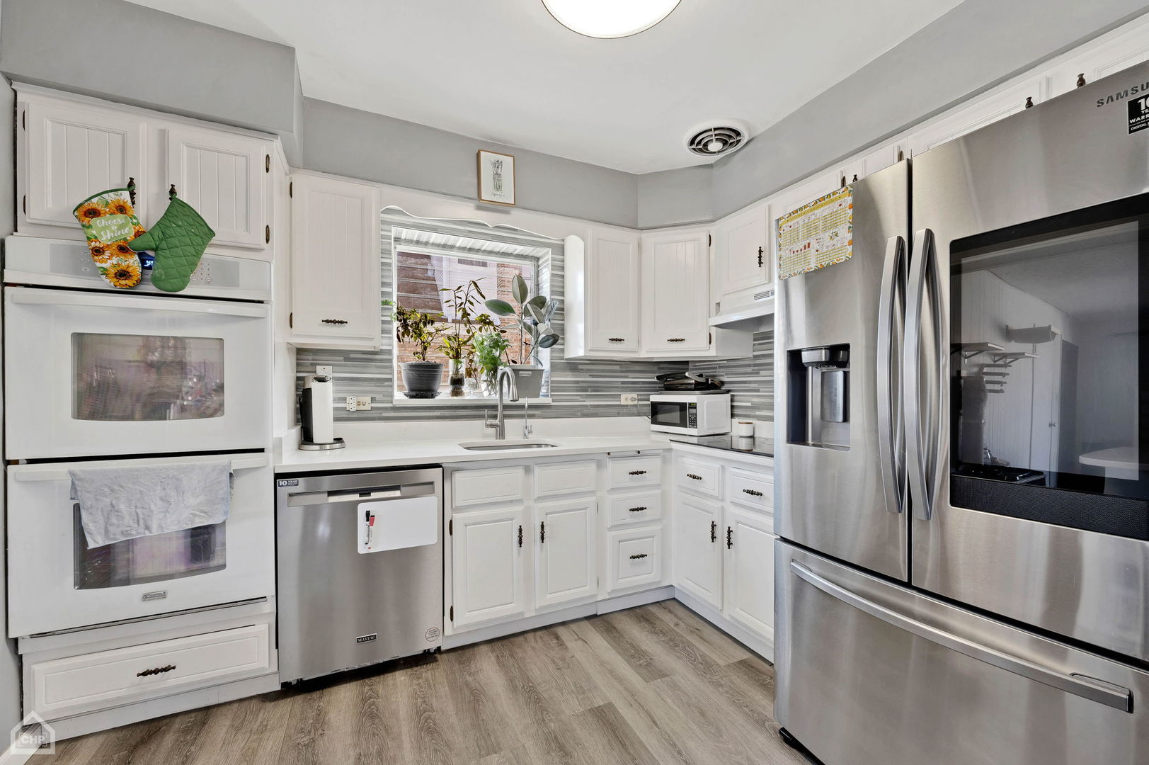 3736 West 70th Street Chicago, IL 60629 - Photo 9 of 21 a kitchen with stainless steel appliances a refrigerator sink and microwave