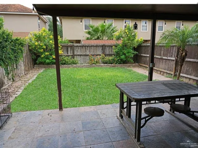 a view of a backyard with a wooden deck and a garden
