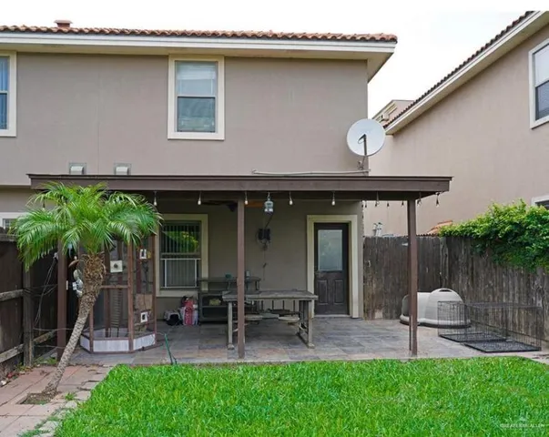 a backyard of a house with table and chairs