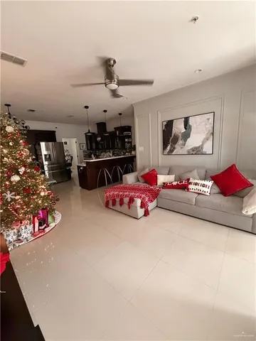 a living room with furniture kitchen and a chandelier