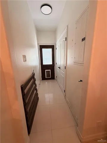 a view of a hallway to rooms and wooden floor