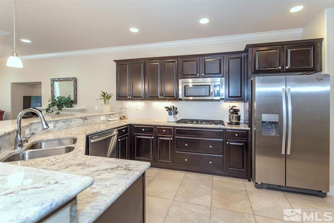 9355 Chalkstone Way Reno, NV 89523 - Photo 3 of 25 a kitchen with granite countertop a refrigerator and a sink
