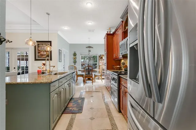 a kitchen with stainless steel appliances a sink stove and refrigerator