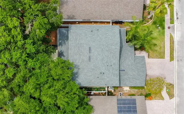 an aerial view of a house with a yard