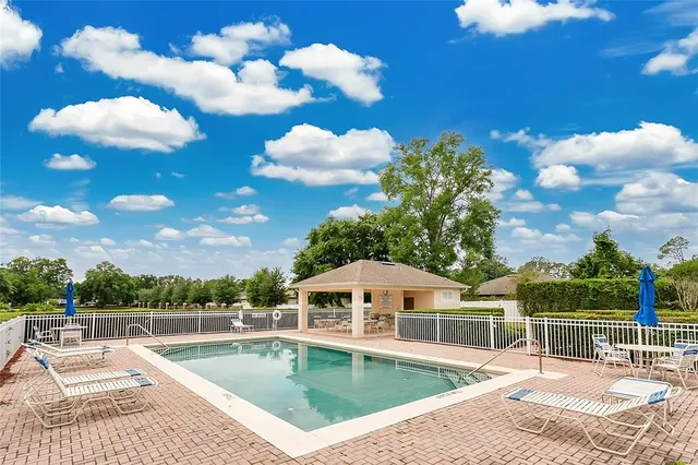 a view of a house with swimming pool and a yard