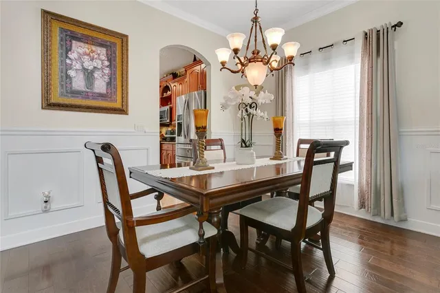 a view of a dining room with furniture wooden floor and chandelier